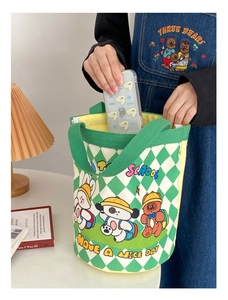Detail of green checkerboard canvas bucket bag with cute cartoon animal illustrations