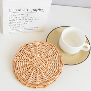 Detailed view of woven round heat resistant table mat with natural rattan texture