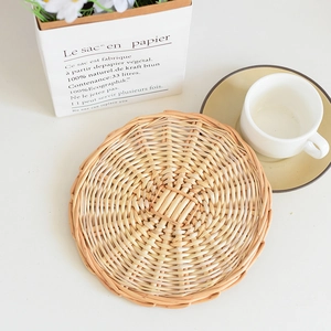 Detailed view of hand-woven round heat-resistant placemat with natural wicker texture