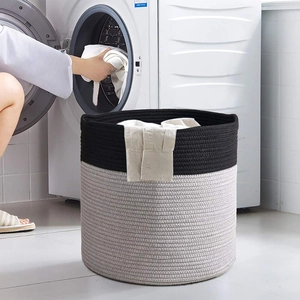 Detail view of woven cotton rope laundry basket with stylish black and grey bicolor design