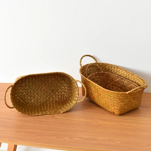 Detailed close-up showing the intricate weave and sturdy handles of natural grass baskets