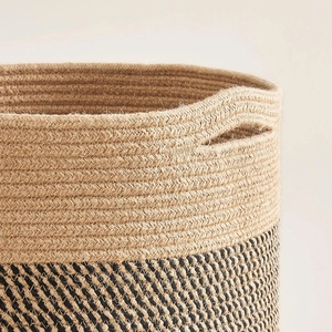 Dual-tone woven cotton rope laundry basket with cutout handles and textured pattern