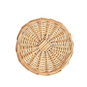 Minimalist woven round heat-resistant table mat in a natural rattan-style design