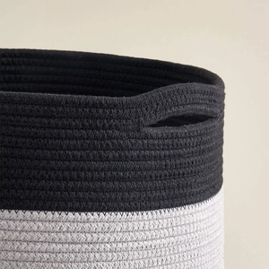 Close-up of dual-tone cotton rope weave pattern and integrated handle of storage basket