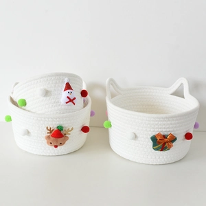 Christmas woven cotton rope storage basket with festive pom poms and reindeer decor