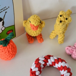 Macro shot of durable hand-woven cotton rope dog toys in animal and fruit shapes