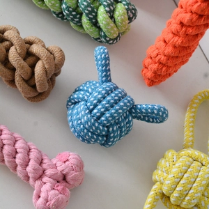 Close-up of durable woven cotton rope knots in various shapes for dog dental cleaning