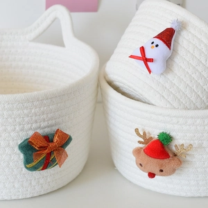 Close-up of woven cotton storage baskets with cute Christmas snowman and reindeer plush details