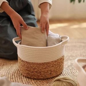 Detail view of woven storage basket with dual handles and cotton rope stitching