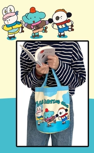 Detail of canvas bucket bag showing Ice Skating Club cartoon prints and handles