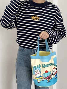 Detail of canvas bucket bag with cute ice skating club illustration and top handle