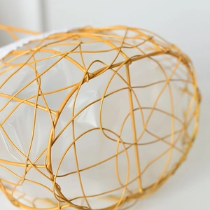 Golden iron woven basket with white lining for gift packaging and flower arrangements