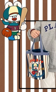 Close-up of cute rabbit illustration and blue striped canvas fabric on the bucket bag