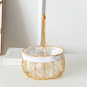 Detail of golden wire woven flower basket with elegant white lace lining and handle