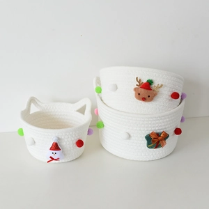 Christmas woven cotton rope storage basket set with festive holiday decorations and pom-poms