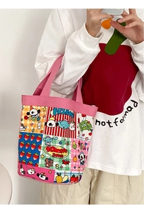 Close-up of pink canvas tote featuring cute cartoon animal patterns and patchwork design