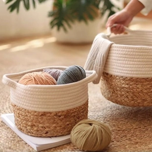 Detail of hand-woven cotton and jute storage basket with dual handles and rustic texture