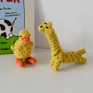 Close-up of hand-woven cotton dog rope toys in cute yellow duck and giraffe shapes