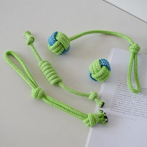 Close-up of durable hand-woven cotton rope dog toys in green and blue-white colors