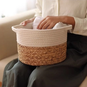Detailed texture of cotton rope and seagrass weaving on a dual-tone storage basket
