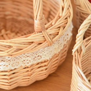 Close-up of hand-woven wicker storage basket featuring delicate cream lace trim