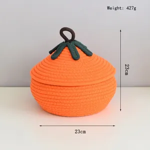 Detailed view of pumpkin-shaped woven cotton rope storage basket with green leaf lid