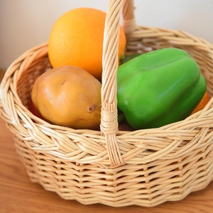 Detailed view of hand-woven wicker basket showing natural texture and vegetable storage
