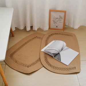 Detail of handcrafted khaki cotton rope woven mats with decorative scalloped edges