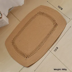 Detail of hand-woven cotton oval rug in khaki with spiral texture and wave patterns