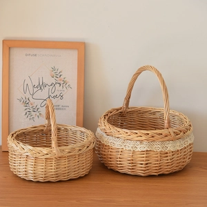 Detailed view of hand-woven wicker baskets with lace trim and elegant handles on a wood table
