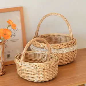 Close-up of handmade wicker storage baskets with white lace trim on wooden table