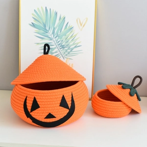 Close-up detail of two pumpkin-shaped cotton woven baskets with lids for storage