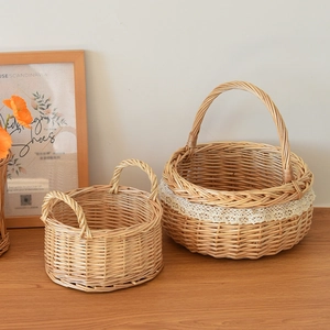 Detail of handcrafted willow picnic baskets with lace trim on a warm wooden table