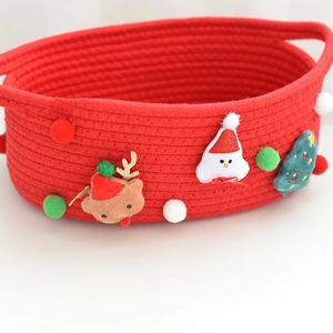 Detailed view of red woven cotton Christmas gift basket with festive character patches