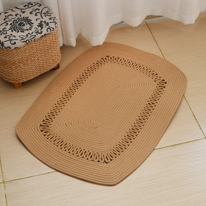 Detailed view of hand-woven oval cotton rope rug with chain-link hollow pattern