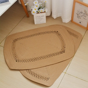 Close-up of handmade woven cotton rope floor mats with intricate lace borders and textures