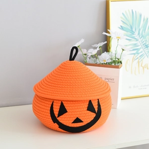 Macro detail of pumpkin shaped cotton rope storage basket with Halloween face and lid