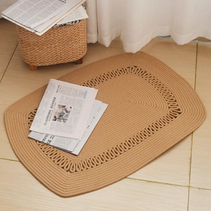 Close-up of handmade cotton rope woven mat with decorative bohemian scalloped edges