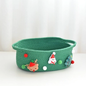 Detail of green woven Christmas gift basket featuring plush reindeer and snowman decorations