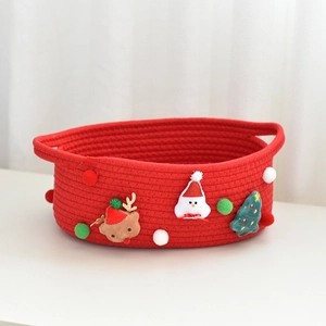 Detail of Christmas gift storage basket with plush reindeer snowman and pom decorations