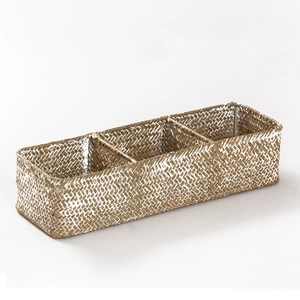 Detail view of woven seagrass basket with three compartments and silver-white coating