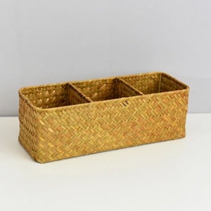 Detail view of a rectangular seagrass woven basket with three separate compartments