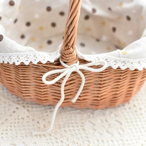 Detail of hand-woven wicker basket with polka dot lining and white lace trim edge