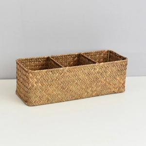 Detail view of the three-section rectangular seagrass storage basket with natural weave