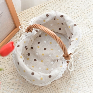 Detail view of woven picnic basket featuring colorful polka dot lining and lace edges