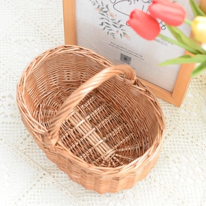 Handwoven wicker picnic basket with handle on lace tablecloth for home storage