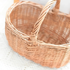 Close-up of hand-woven wicker basket featuring detailed natural willow texture on white lace