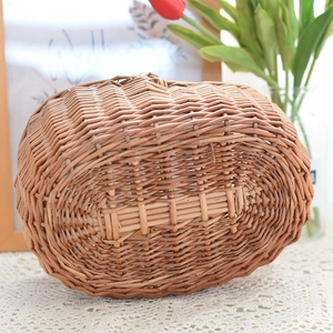 Detailed close-up showing the sturdy woven texture and base of the willow picnic basket