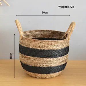 Detail of hand-woven storage basket with natural seagrass fibers and black striped pattern