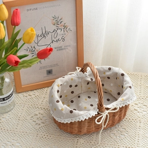 Handwoven willow picnic basket with polka dot fabric liner and white lace trim detail